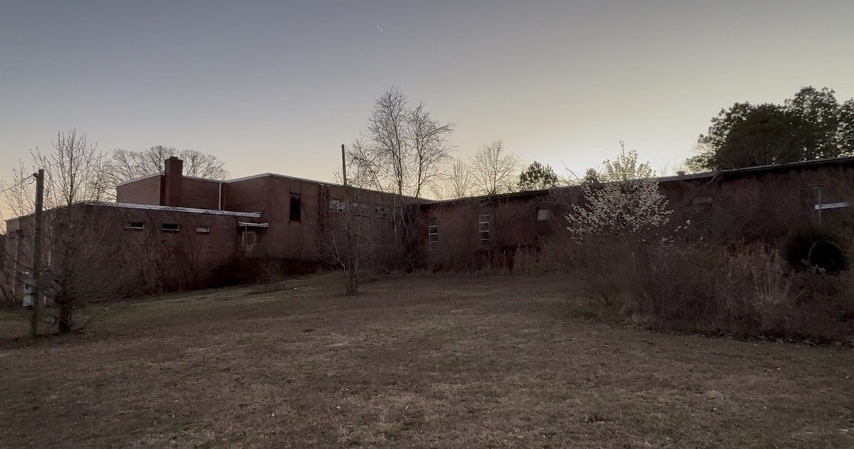 Rear view of the school building, showing the structure awaiting restoration